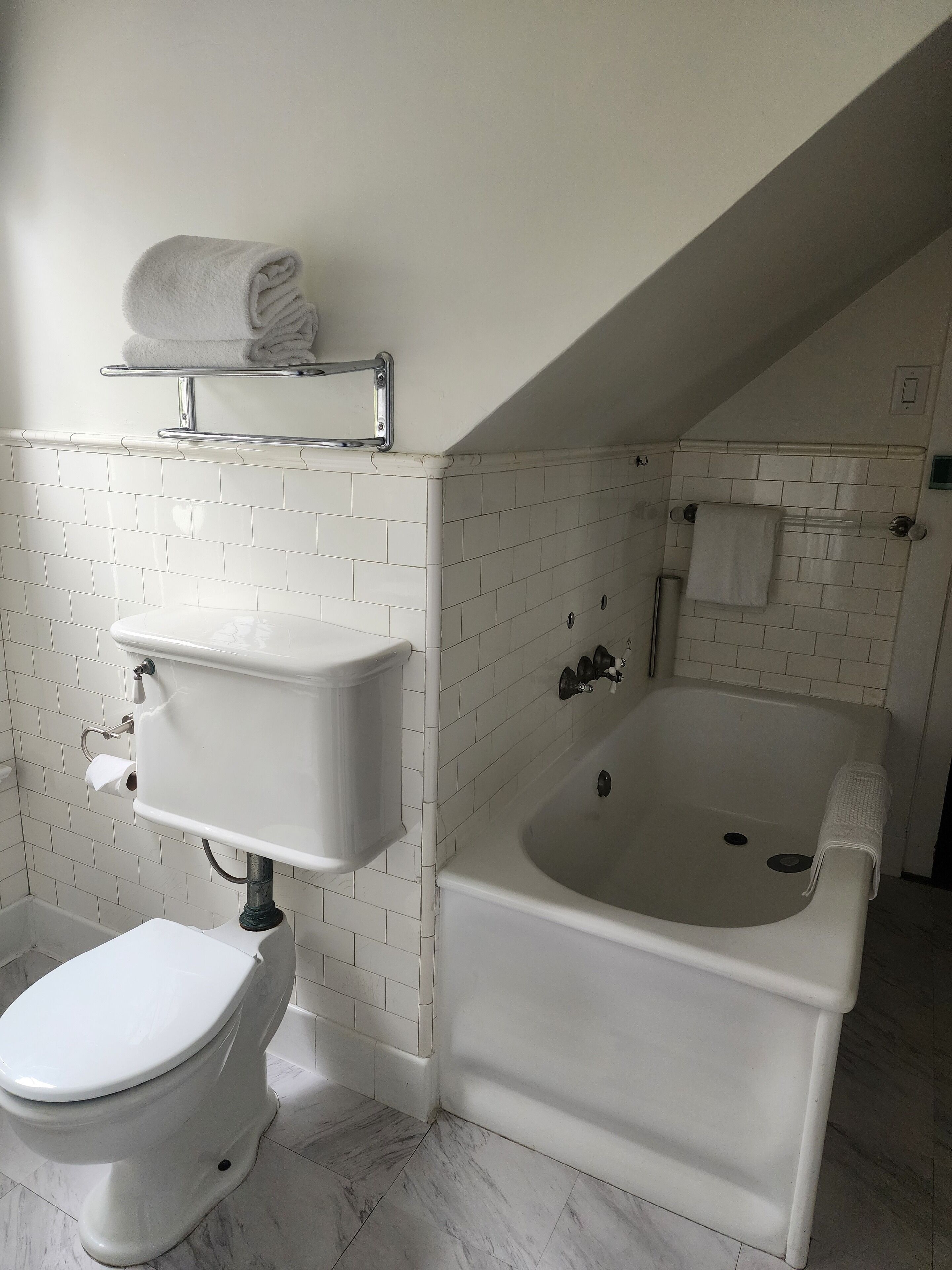 A bathroom with a toilet, a sink, and a bathtub.