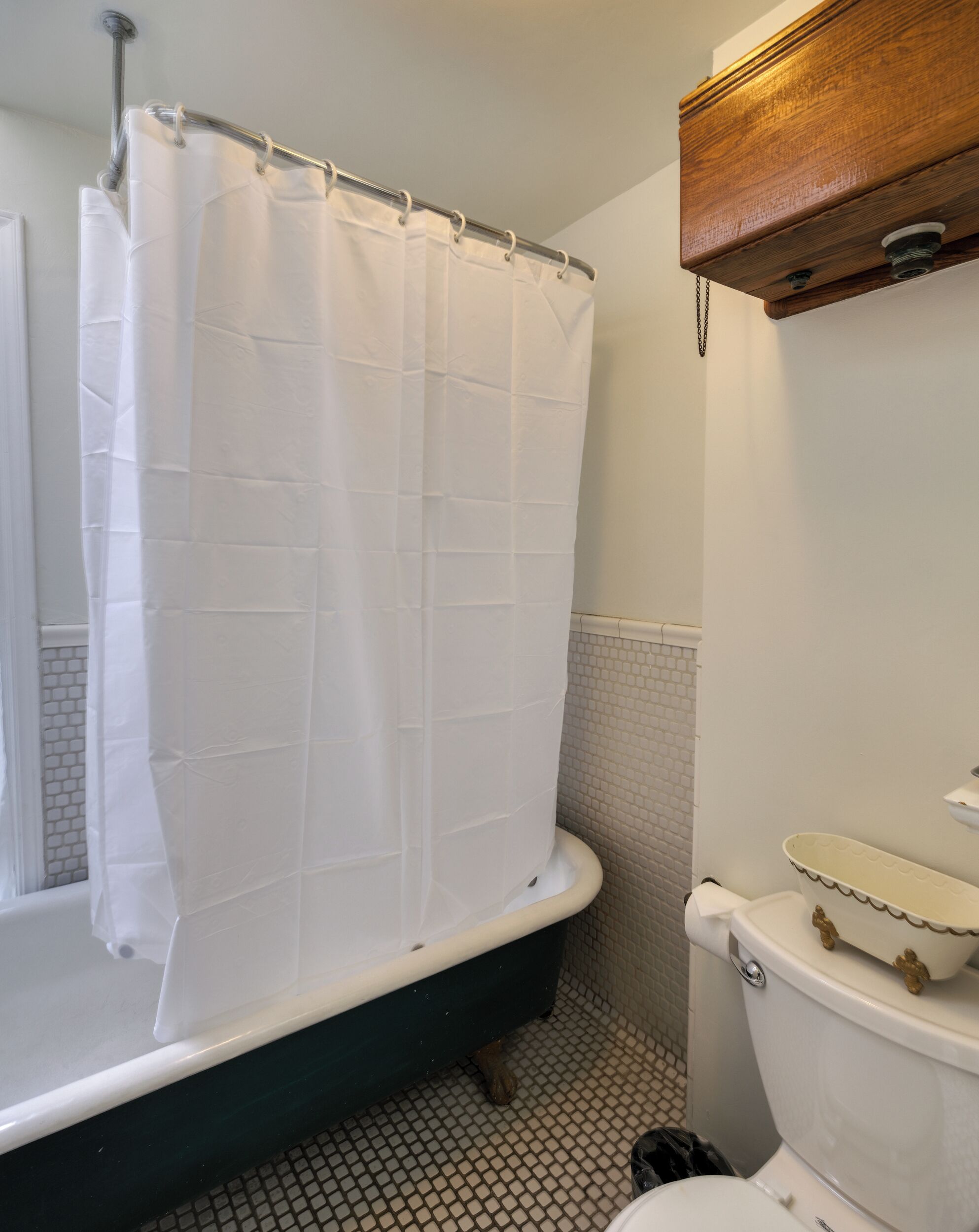 A bathroom with a bathtub, a toilet, and a sink.