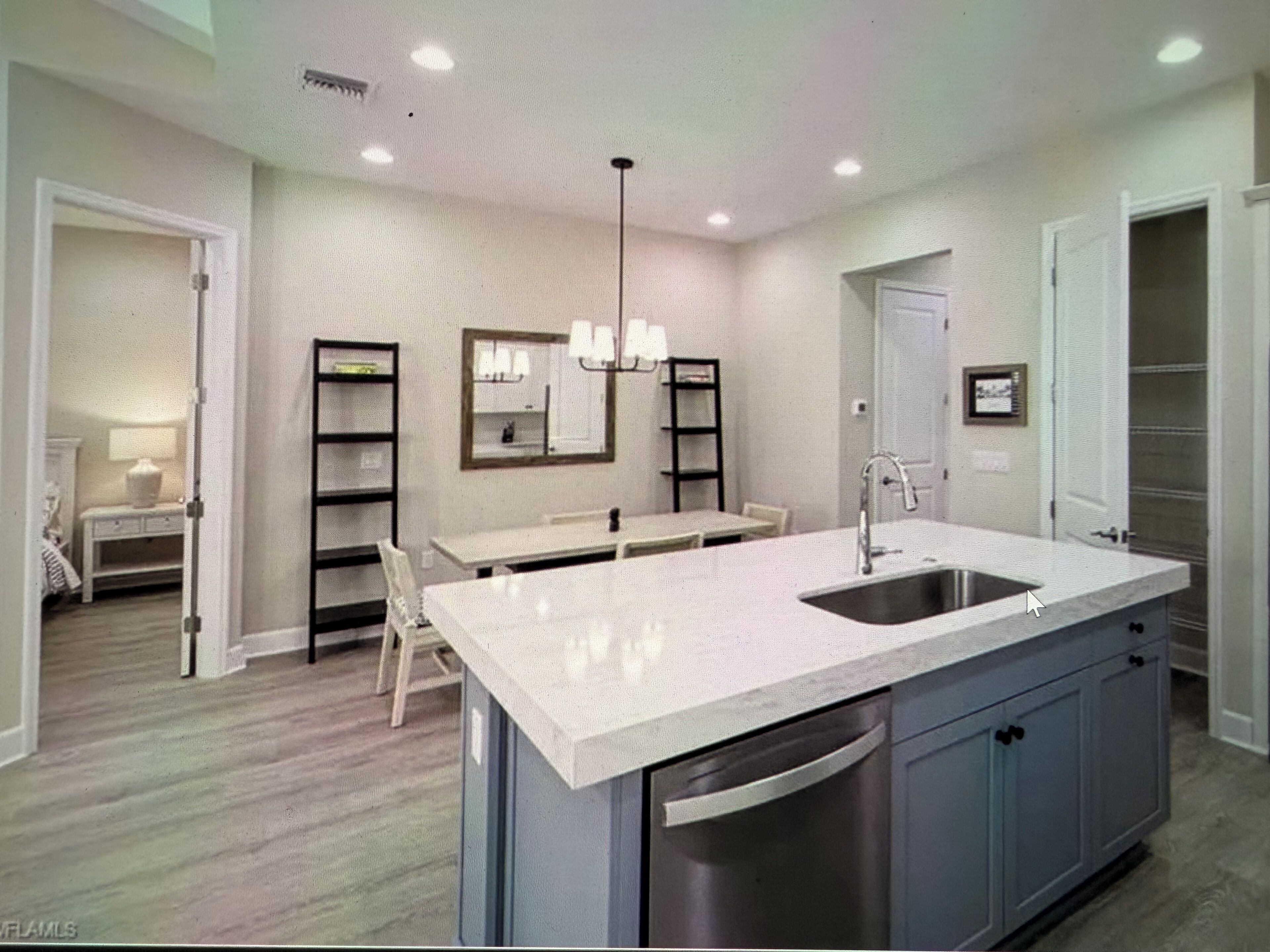 A modern kitchen with a central island, built-in appliances, and a dining area with a bench.