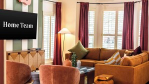 A living room with a sofa, armchairs, a coffee table, and a TV. - Upscale Escape • Pool, Hot Tub, Game Room, Firepit (San Antonio)