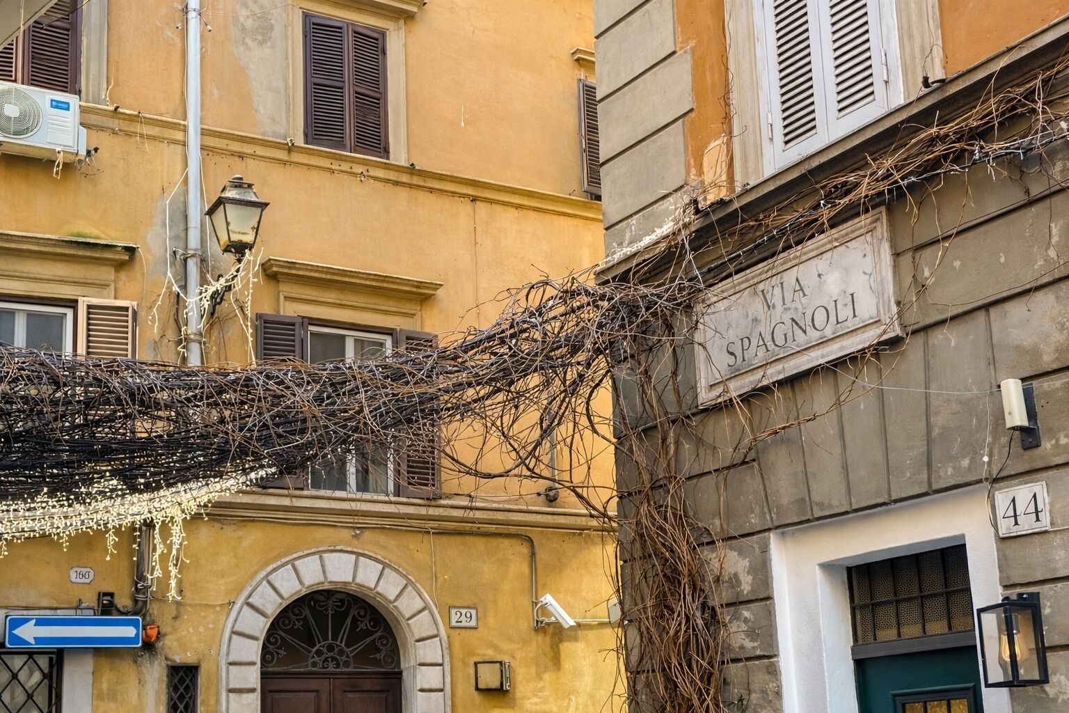 A building with a sign reading "Via Spagnoli" and the number "29" on the facade.