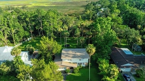 A residential area with houses surrounded by lush greenery and a clear view of the landscape. - The Marsh House (Brunswick)