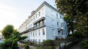 Un immeuble à plusieurs étages, doté d’une façade blanche, d’un balcon au deuxième étage et d’une enseigne indiquant « Montpelier Villas ».