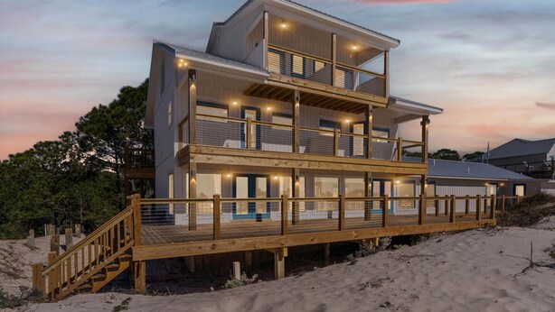 A multi-story beachfront house with a wooden deck and balconies. - High Point Hideaway on the Sand Dunes - Unit 2 (Dauphin Island)