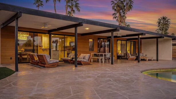 A modern outdoor patio with stone flooring, seating areas, and a pool. - Desert Escape- Pool, Spa & Mountain Views (Palm Springs)