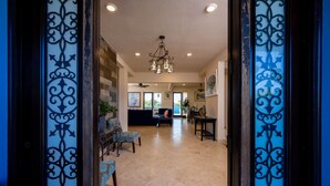 A spacious living area with a sofa, chairs, a coffee table, and a chandelier. - BK Villas Light House 4br/4ba sleeps 8 (Enterprise)