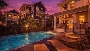 A two-story house with a swimming pool, lounge chairs, and a wooden deck. - Prescription for Paradise by Stay on 30a (Santa Rosa Beach)