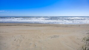 A beach with a clear sky and ocean waves. - 8388 Family Island Retreat | Steps to Beach (Avon)