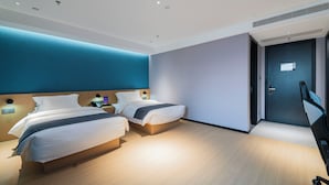 A modern hotel room with two beds, a desk, and a TV. - XINGHEHOTEL (Xi'an)