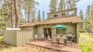 A cabin with a patio, outdoor seating, and a grill. - Sunriver retreat w/ hot tub, SHARC passes, pet-friendly (Sunriver)