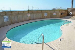 A swimming pool with a wooden fence and a 'No Diving' sign. - Sea Mystique 204 - Oceanfront Condo in Garden City Beach (Garden City)