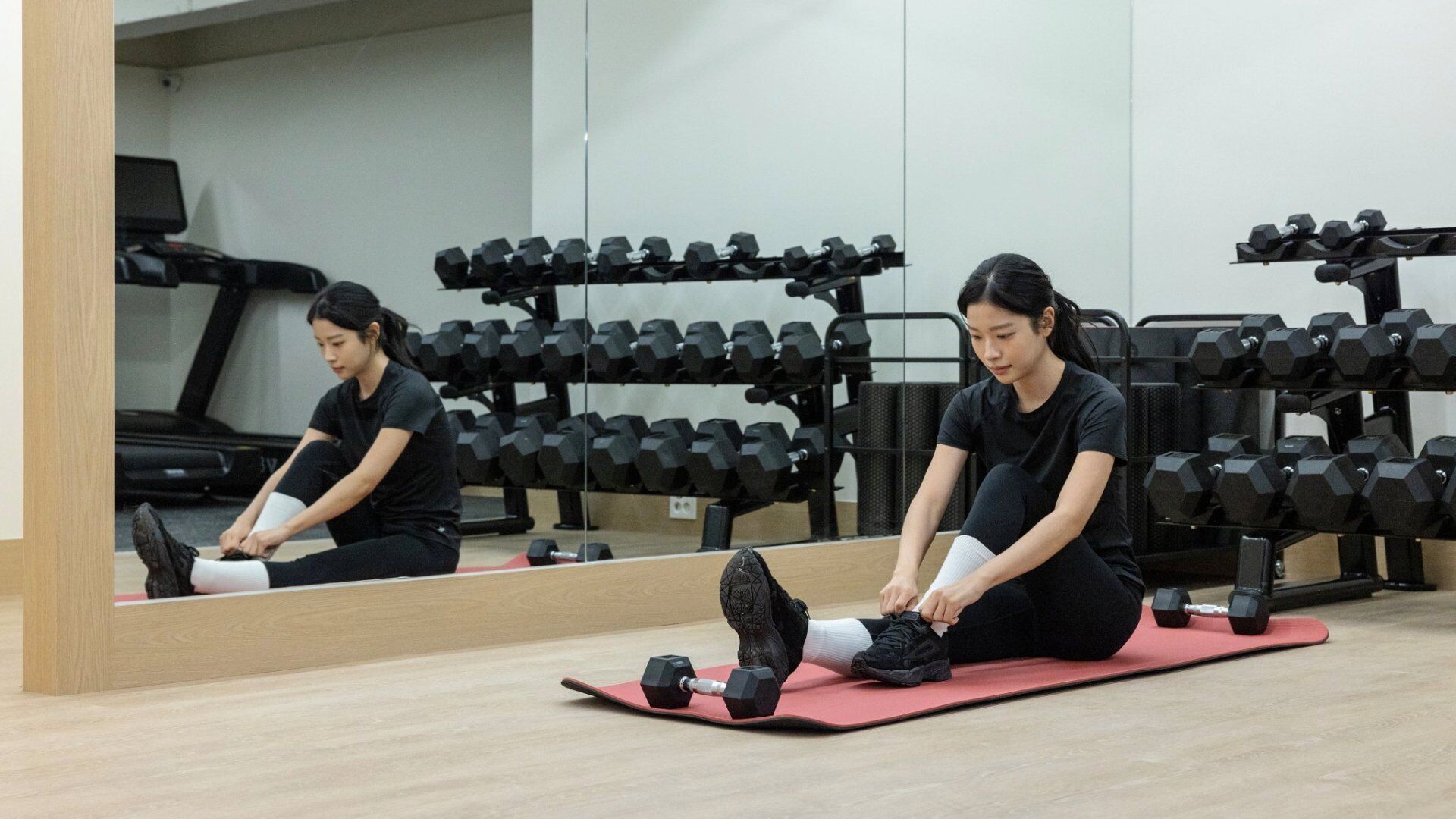 A gym with exercise equipment and a treadmill.