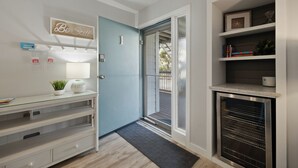 A modern kitchen with a built-in oven, a glass door entrance, and a 'Be Still' sign on the wall. - Fully renovated 2BR/2BA within walking distance to the beach and so much to do! (Hilton Head Island)