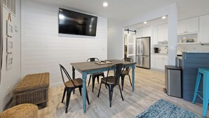 A modern kitchen with white cabinetry, a built-in oven, and a stainless steel refrigerator. - Fully renovated 2BR/2BA within walking distance to the beach and so much to do! (Hilton Head Island)