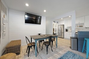 A modern kitchen with white cabinetry, a built-in oven, and a stainless steel refrigerator. - Fully renovated 2BR/2BA within walking distance to the beach and so much to do! (Hilton Head Island)