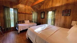 A cabin-style room with two beds, wooden walls, and a large window. - Spacious 1-Bedroom Cabin with Full Kitchen, Vaulted Ceiling & Outdoor Space (Zwolle)