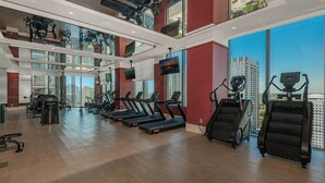 A modern gym with treadmills, ellipticals, and weight machines. - Crosby 31 | Signature Skyline Residence (Miami)