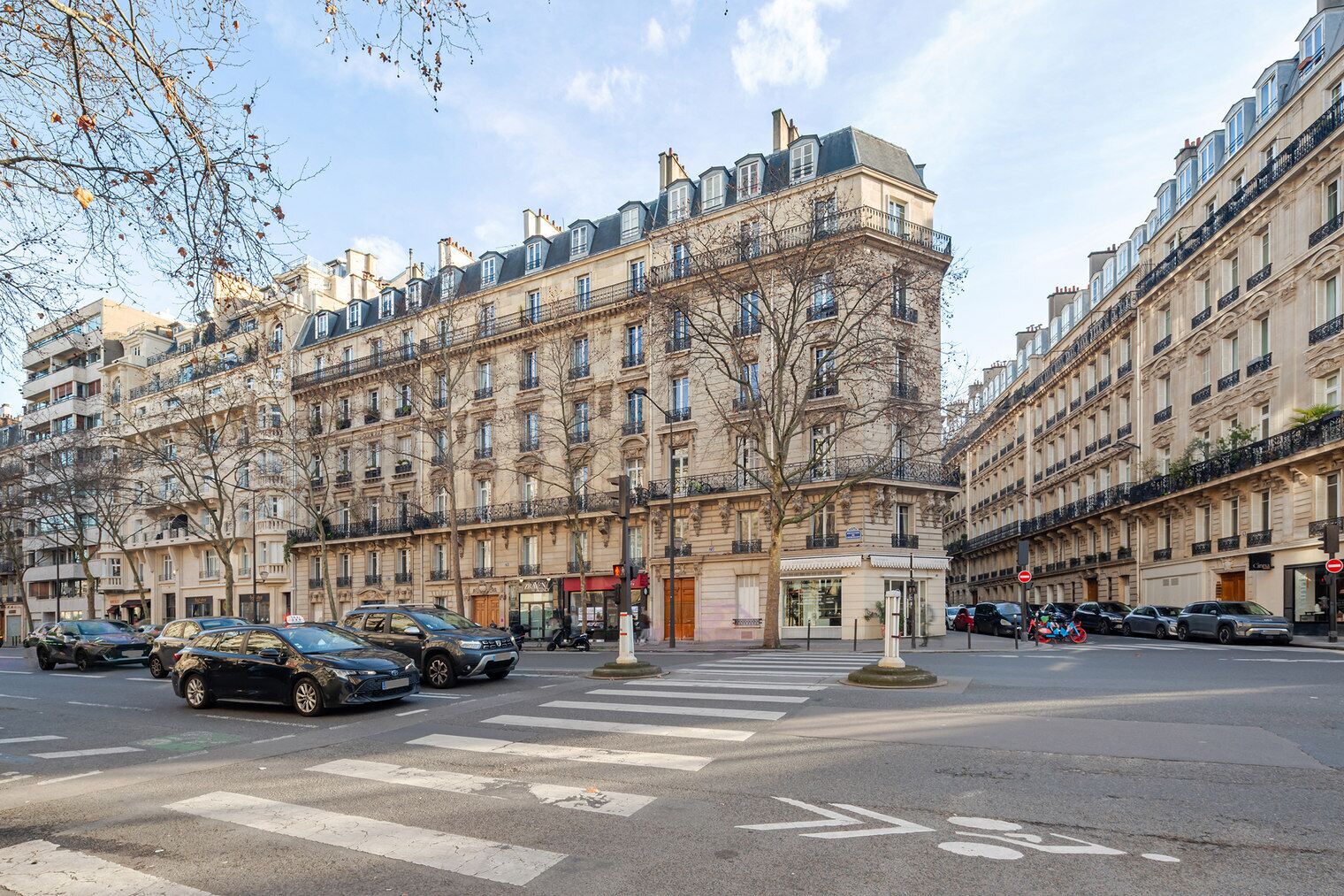 A multi-story building with a classic architectural style, featuring balconies and large windows.