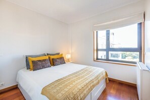 A bedroom with a bed, pillows, a window, and a radiator. - Foz Premium Retreat with Parking (Porto)