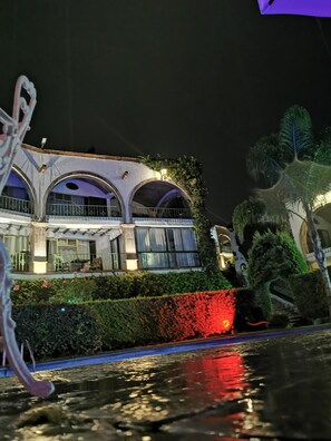 A building with arched balconies and a water feature in front. - Suite vista hermosa  (San Miguel de Allende)