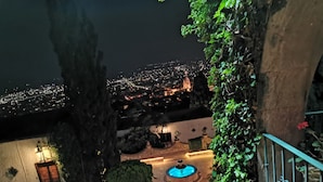 A nighttime view of a cityscape with a pool area in the foreground. - Suite vista hermosa  (San Miguel de Allende)