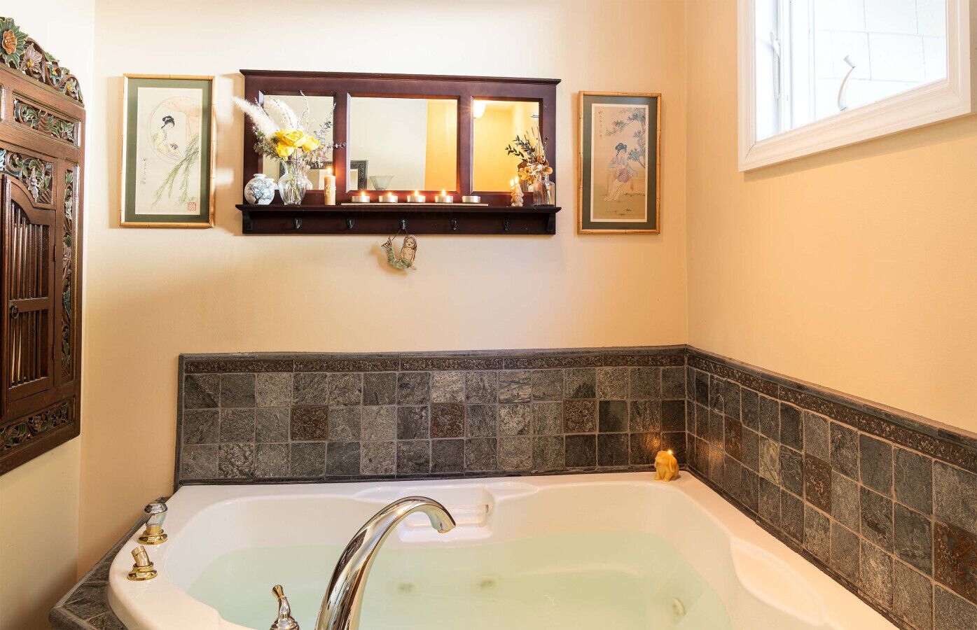 Un baño con una bañera grande, un tocador de madera con un espejo y un salpicadero de azulejos.