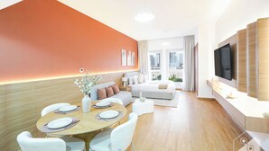 A modern hotel room with a dining area, a sofa, a TV mounted on the wall, and a city view through large windows. - Vibrant Luxury Studio Emirates Gardens Dubai (Dubai)