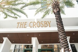 The entrance of The Crosby hotel with a palm tree in the foreground. - 2BR/2BA Palm Oasis at The Crosby (Miami)