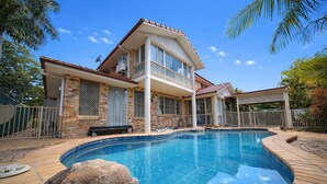 A two-story house with a swimming pool, a covered patio, and a fenced backyard. - Spacious 5BR Family Home with Pool in Robertson (Robertson)