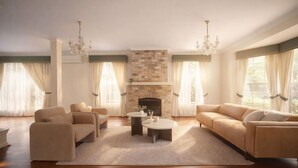 A spacious living room with a fireplace, comfortable seating, and large windows. - Spacious 5BR Family Home with Pool in Robertson (Robertson)