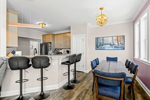 Dining Area - Blue velvet seating, gold chandelier light, and wall-to-wall windows make every meal feel relaxed. - Lakefront Luxury - Beach, Dock, Deck @ Lake Anna (Mineral)