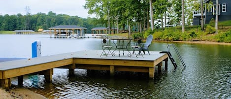 Dock - Bistro table and chairs on the dock invite you to dine lakeside, with a swim ladder for easy water access.