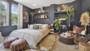 A modern bedroom with a large bed, bedside tables, a chair, and a view of the outdoors. - Bohome Reserve:  Chicago Wicker Park • Sauna • Chef's Kitchen • Outdoor Lounging (Chicago)