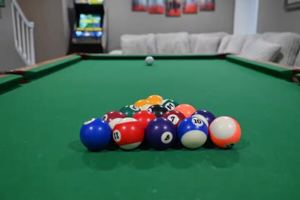 A pool table with a white cue ball and a colorful arrangement of numbered balls. - City Cabin Hideaway w/ Spa, Pool Table & Arcade (Greeley)