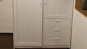 A white wardrobe with two doors and three drawers. - Studio Apartment 103 In Malabar Hill By Florastay (Mumbai)
