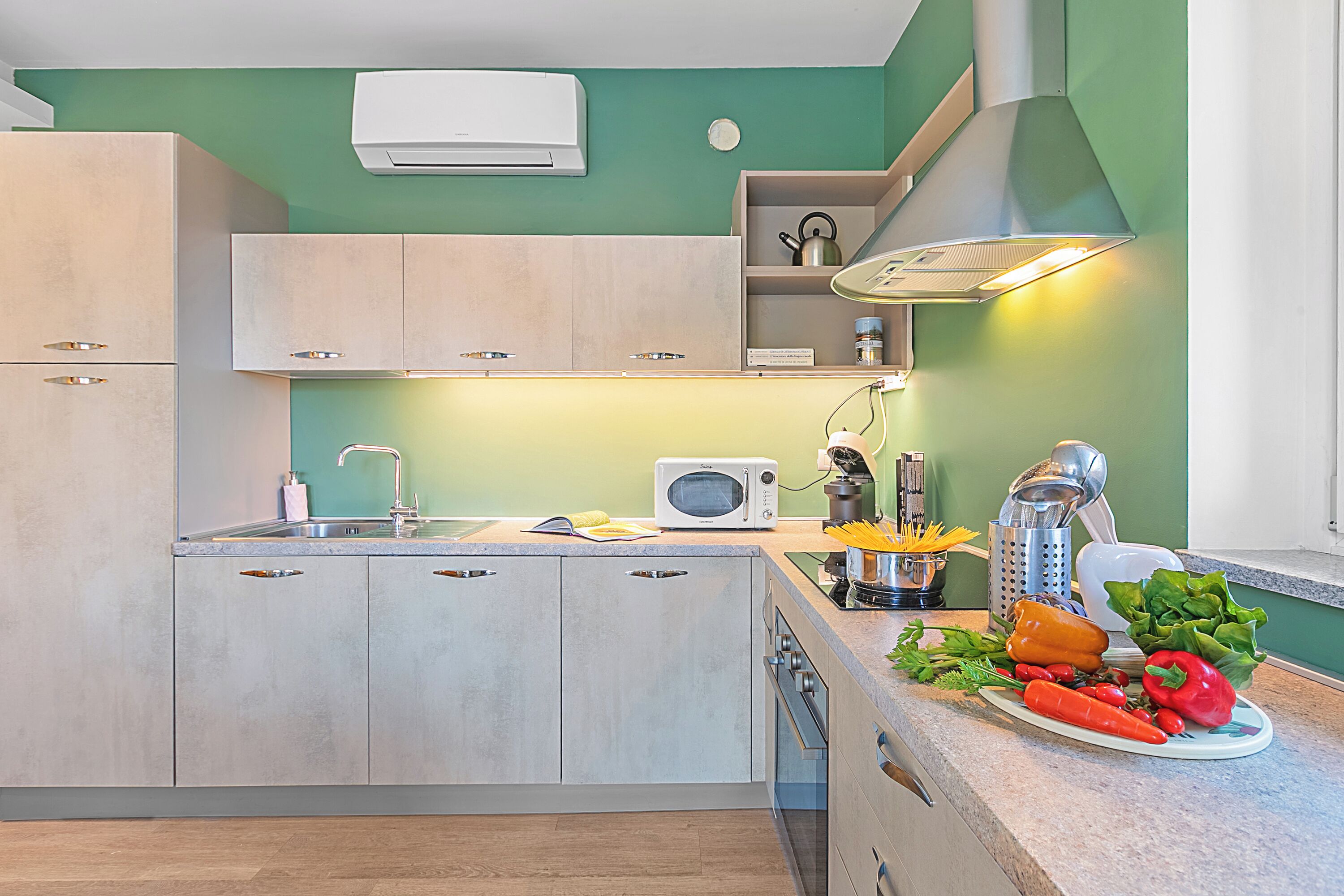 Cozinha moderna com forno embutido, micro-ondas e pia.