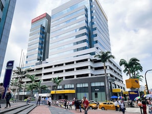 A multi-story building with a modern architectural design, featuring a prominent sign for 'Mapfere Seguros' at the top.