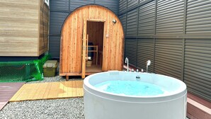 A spa area with a wooden archway leading to a room, a large hot tub, and a wooden deck. - Solana Fuji Gotenba (Gotemba)