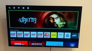 A television screen displaying a channel guide with various options including 'News 18', 'Spotlight', 'Live TV', and 'Movie'.