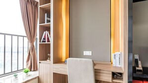 A modern workspace with a desk, chair, and shelving unit. - Yazhi Apartment (Guangzhou)
