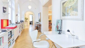 A spacious room with a wooden floor, white furniture, and a large painting on the wall. - Villa Astarte: An elegant apartment located in the center of Sorrento, with Free WI-FI. (Sorrento)