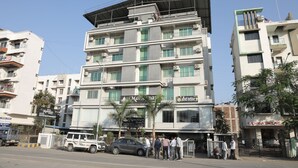 A multi-story building with balconies, a sign for 'Mariana Homes', and a 'Rachana Enclave' sign. - hotel manomay homes (Nagpur)