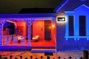 Evening exterior showing dynamic lighting and clear property identification.