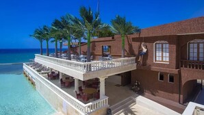 A beachfront hotel with a poolside area, outdoor seating, and a view of the ocean. - Villa Ocean Dream 3BR Oasis and guesthouse (Sosúa)