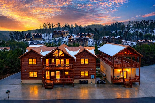 Golden-hour mountain retreat glowing at dusk, with expansive decks, cozy cabin charm, and sweeping Smoky Mountain views in every direction.