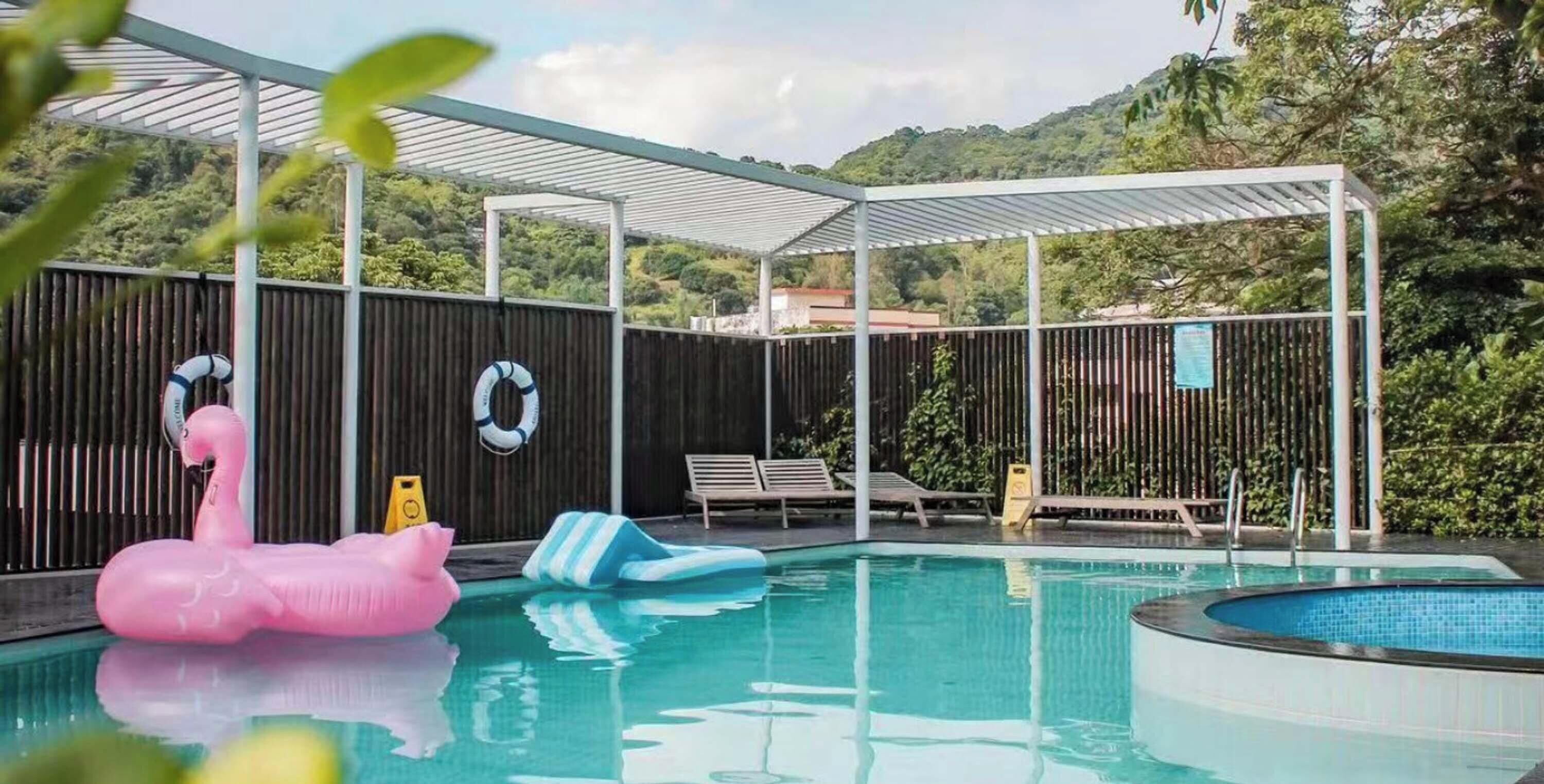 Seasonal outdoor pool, open 2:00 PM to 6:00 PM, pool umbrellas