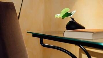 A chair, a table, a lamp, and a plant.