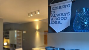 A modern dining area with a sign that reads "KISSING IS ALWAYS A GOOD IDEA." - Casa Magenta_Private Garden & Swimming Pool in the Village (Moniga del Garda)
