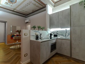 A modern kitchen with a built-in oven, a sink, and a marble countertop. - La Dama_Elegante, Affrescato and Roof Top Lake View (Salò)