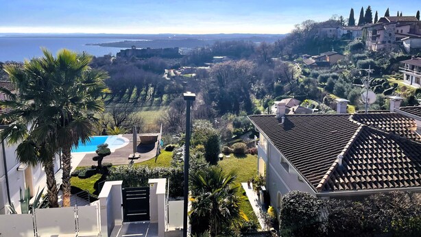 A residential area with a view of the sea, a swimming pool, and a well-maintained garden. - Casa Pratello_Design and relax with a view of the lake (Padenghe sul Garda)